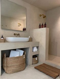 a bathroom with a sink, mirror and towel rack