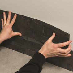 two hands reaching for something on the floor