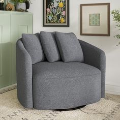 a grey chair sitting on top of a rug in a living room