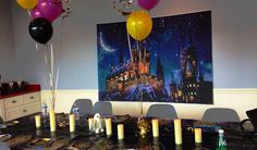 a dining room table with balloons and candles on it