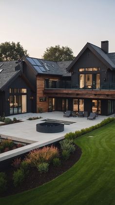 a large house with a fire pit in the middle of it's front yard