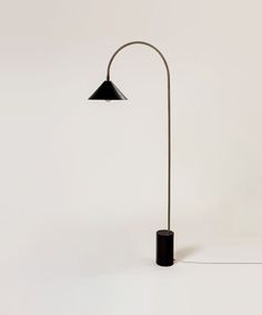 a floor lamp with a black shade on the top and one light on the bottom