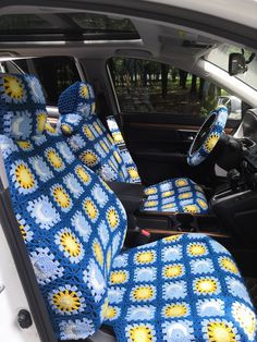 the interior of a car is decorated with blue and yellow crochet