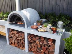 an outdoor pizza oven made out of firewood