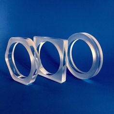 three pieces of clear plastic on a blue background