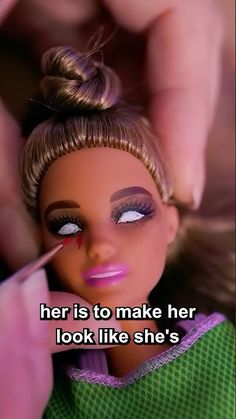 a barbie doll being painted by someone's hand with the caption, her is to make her look like she's