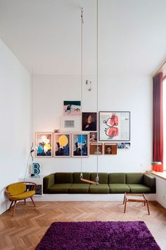 a living room filled with furniture and pictures on the wall