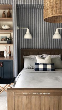 a bed sitting in a bedroom next to a shelf filled with vases and other items