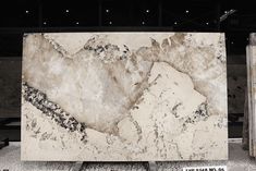 a large marble slab is on display in a building with black and white paint all over it