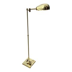 a lamp that is sitting on top of a white surface with a black and gold base