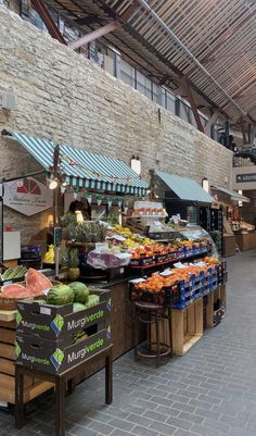 an outdoor market with fruits and vegetables on display