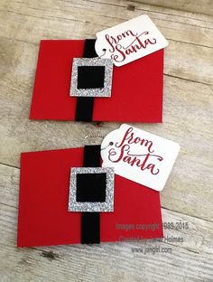 two santas made out of red and black paper with silver glitter on the top