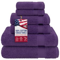 purple towels stacked on top of each other with an american flag tag in the middle