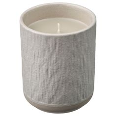 a white candle that is inside of a cup