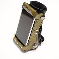 a cell phone in a leather case with rivets and studs on it