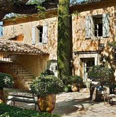 an outside view of a house with trees and bushes