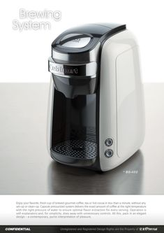 a white coffee maker sitting on top of a table next to a black and silver machine