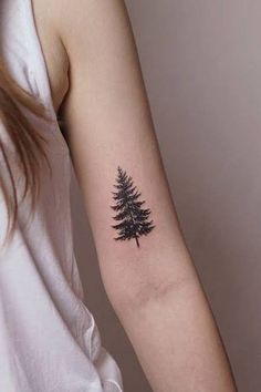 a small pine tree tattoo on the arm