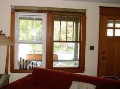 a living room filled with furniture and a lamp next to a window covered in wood