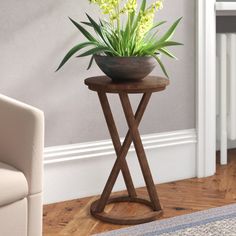 a potted plant sitting on top of a wooden stand