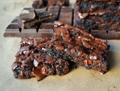 three pieces of chocolate brownie sitting on top of a table next to each other