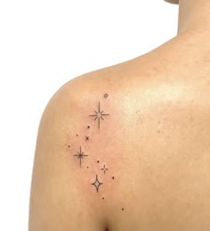 the back of a woman's shoulder with stars on it