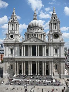 a large white building with two towers and a clock