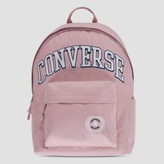 Carry your stuff in All Star style with this backpack from Converse. It's made of durable poly fabric and features a varsity style applique patch as well as the Chuck Patch logo. The main compartment has a 2-way zip closure and is spacious enough to hold text books, a change of clothes, your lunch or any other items you want to take along for the day. One the back there is a zippered padded compartment that can be used to store your laptop or tablet and the front zip pocket can be used to secure Casual Campus Bags For Back To School, Casual Back To School Campus Bag, Casual Bags For College And Back To School, Casual Nylon College Backpack, Sporty Backpack For College And Back To School, Trendy Pink Backpack With Pockets, Sporty Softback Backpack For Students, Casual School Backpack With Logo Patch, College Backpack For Back To School