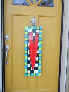 a yellow door with a red heart painted on it