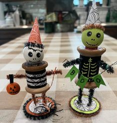 two halloween decorations sitting on top of a table