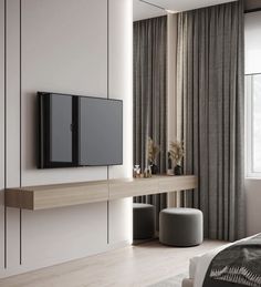 a bedroom with a large tv mounted on the wall