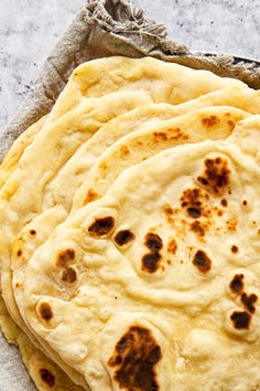 four flatbreads on a towel with text overlay reading how to make easy flat bread