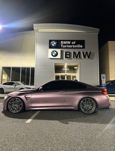 a car parked in front of a bmw dealership