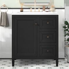 a bathroom with a sink, mirror and towel rack in it's corner on the tiled floor