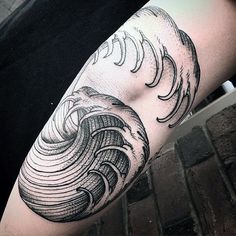 a person with a black and white tattoo on their arm