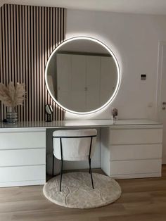 a white vanity with a round mirror on it's side and a chair in front of it