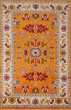 an orange and white rug with many different designs on the border, in various colors