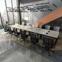 an empty conference room with black chairs and a long table in front of a large window