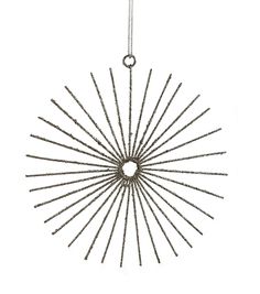 a metal sunburst hanging from a chain