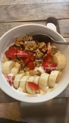 a bowl filled with granola, bananas and strawberries