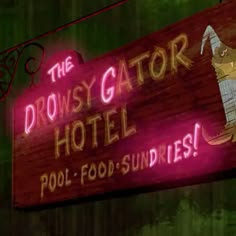 a neon sign that says the prowsy gator hotel pool - food - sundries