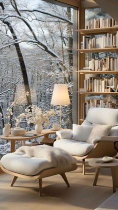 a living room filled with furniture and a large window covered in bookshelves next to a forest