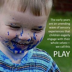 a young boy with blue paint on his face and the words play in front of him