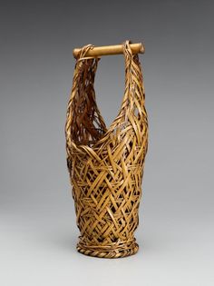 a woven basket with a wooden handle