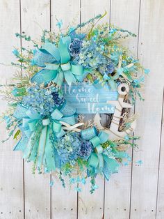 a wreath with an anchor and blue flowers