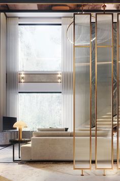 a living room filled with furniture next to a tall glass door that leads to a balcony