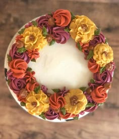 a cake decorated with flowers on top of a wooden table