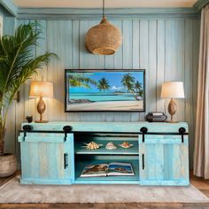 an entertainment center in the corner of a room with two lamps and a painting on the wall