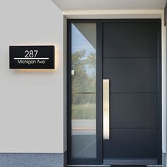 a black door with the number 287 on it and an illuminated sign above it