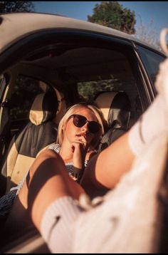 a woman sitting in the back seat of a car